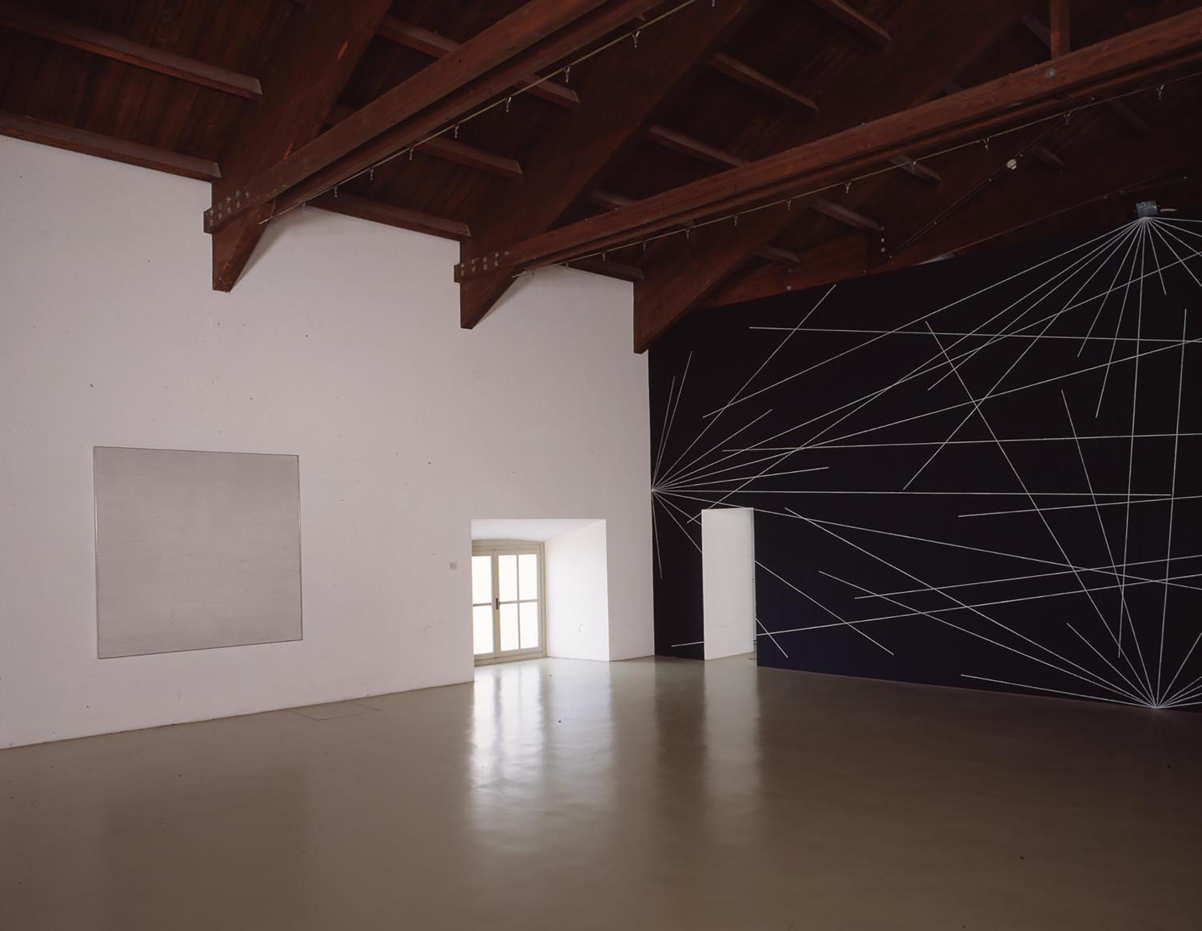 Agnes Martin, Untitled #11, 1977 and Sol LeWitt, A six inch (15 cm) grid covering each of the four black walls. White lines to points on the grids. 1st wall: 24 lines from the center; 2nd wall: 12 lines from the midpoint of each of the sides; 3rd wall: 12 lines from each corner; 4th wall: 24 lines from the center, 12 lines from the midpoint of each of the sides, 12 lines from each corner, 1976